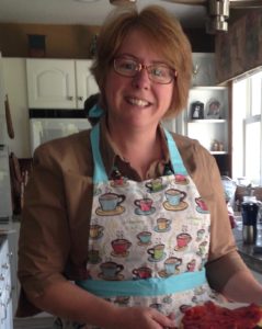 Cindy wearing apron in the kitching